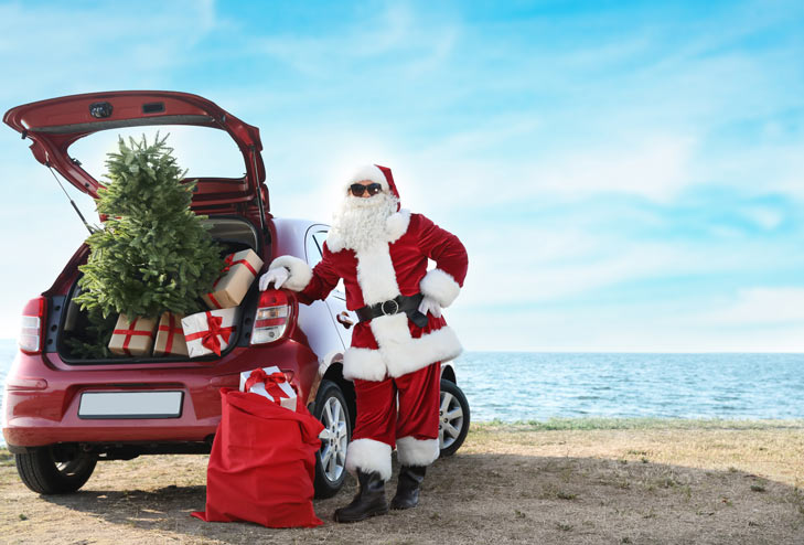 Santa with Christmas tree in car