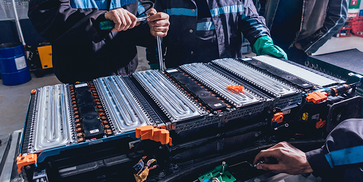 Photo of people working on an EV battery